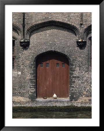 Two Ducks Sit In Doorway That Opens Directly Onto A Canal by Joseph H. Bailey Pricing Limited Edition Print image