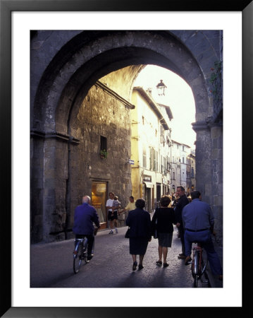 Pedestrians Entering Archway, Lucca, Italy by John & Lisa Merrill Pricing Limited Edition Print image