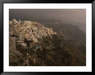 The Village Of Thira Cascades Down A Cliff Side On Santorini Island by Tino Soriano Pricing Limited Edition Print image