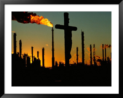 A Crucifix Is Silhouetted Against Refinery Stacks by Sam Kittner Pricing Limited Edition Print image