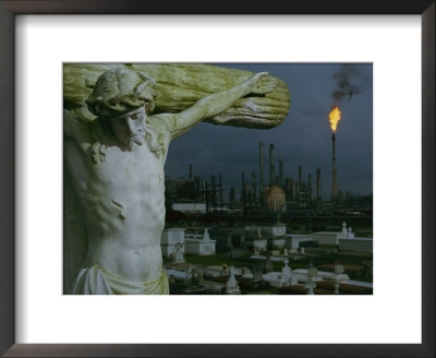 A Crucifixion Statue In Holy Rosary Cemetery Overlooks Petrochemical Plants by Joel Sartore Pricing Limited Edition Print image