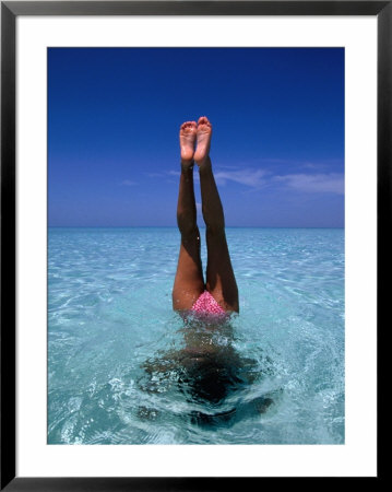 A Female Swimming In Crystal Clear Waters, Bahamas by Greg Johnston Pricing Limited Edition Print image