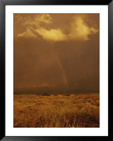 Storm Clouds And A Rainbow Appear Over The Prairie Landscape by Paul Damien Pricing Limited Edition Print image