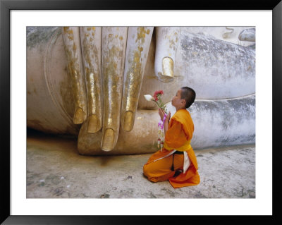Novice Buddhist Monk Kneeling Beneath The Phra Atchana Buddha Statue, Sukhothai Province, Thailand by Gavin Hellier Pricing Limited Edition Print image