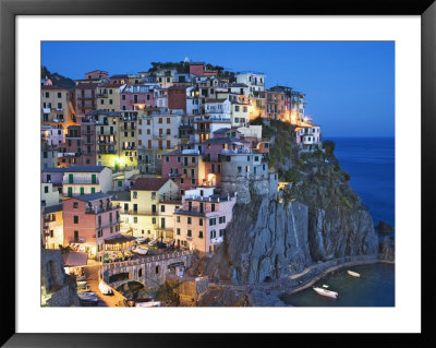 Dusk Falls On A Hillside Town Overlooking The Mediterranean Sea, Manarola, Cinque Terre, Italy by Dennis Flaherty Pricing Limited Edition Print image