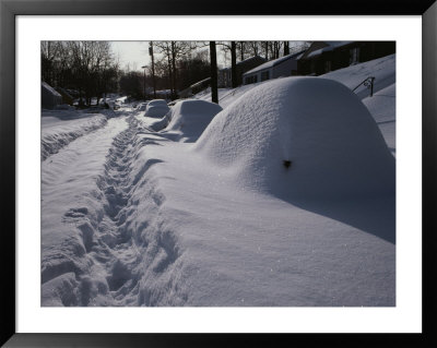 Mounds Of Snow Cover Cars On An Unplowed Street After A Bad Storm by Stephen St. John Pricing Limited Edition Print image