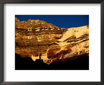 A Photographer Is Silhouetted Against A Dramatic Mountain Backdrop by Raymond Gehman Pricing Limited Edition Print image