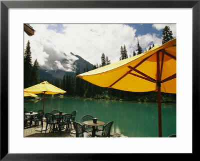 Tables And Umbrellas On The Patio At The Shore Of Emerald Lake by Michael Melford Pricing Limited Edition Print image