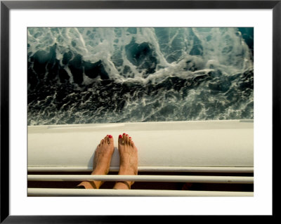 Woman's Feet Standing On The Railing Of A Cruise Ship With Sea Below by Todd Gipstein Pricing Limited Edition Print image