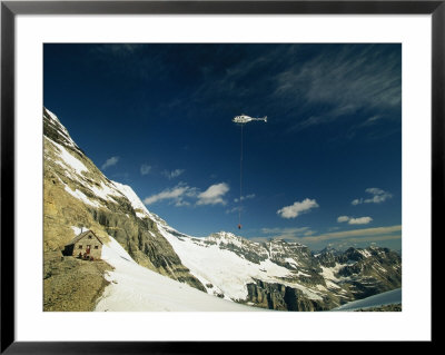 Person Dangles From A Helicopter At Abbot Pass In Yoho National Park by Michael Melford Pricing Limited Edition Print image