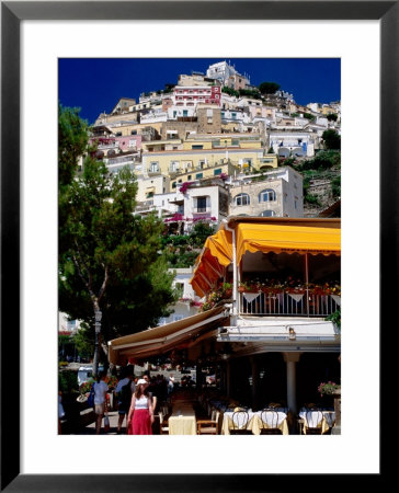 Waterfront Restaurant With Steep Terrace Of Houses In Background, Positano, Italy by Dallas Stribley Pricing Limited Edition Print image