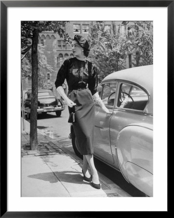Katherine Cassidy Wearing A Red Fraostmann Wool Skirt And Black Sweater Beneath Black Cardigan by Nina Leen Pricing Limited Edition Print image