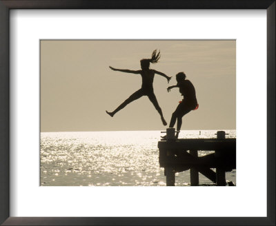 Silhouette Of Girls Jumping Off Pier by Anne Flinn Powell Pricing Limited Edition Print image