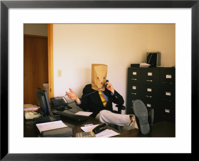 Office Anonymity- Man With A Bag Over His Head Talks On The Telephone by Joel Sartore Pricing Limited Edition Print image