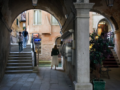 Woman Uses Telephone On Street Near St. Mark's Square, Venice, Italy by Robert Eighmie Pricing Limited Edition Print image