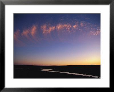 Clouds Form Interesting Patterns In The Evening Sky by Paul Nicklen Pricing Limited Edition Print image