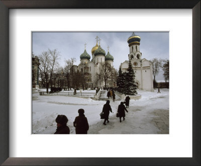 Russian Women, Dressed In Black, Walk Across A Snowy Square Toward Two Orthodox Churches by James L. Stanfield Pricing Limited Edition Print image
