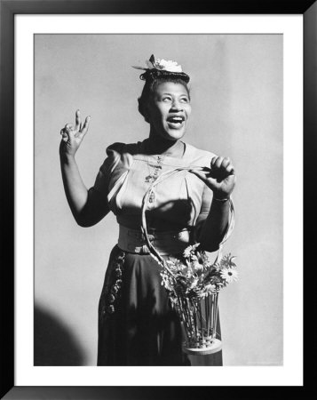Singer Ella Fitzgerald Holding A Basket Of Flowers As She Sings A Tisket, A Tasket by Eliot Elisofon Pricing Limited Edition Print image