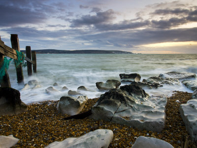Sea Defences At Hurst Spit, Looking Across To The Isle Of Wight And The Needles, Hampshire, England by Adam Burton Pricing Limited Edition Print image