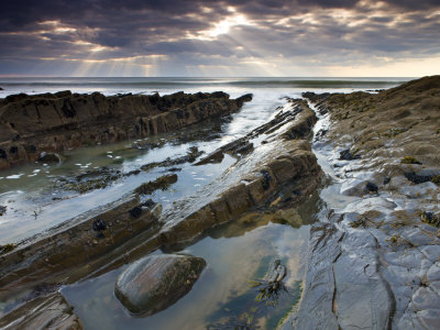 Rockpools And Ledges Beneath Cloudy Sky, Sandymouth Beach, Cornwall, England by Adam Burton Pricing Limited Edition Print image