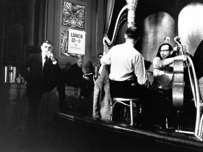 Clark Gable Taking A Cigarette Break As Orchestra Relaxes On Stage During Rehearsals by Leonard Mccombe Pricing Limited Edition Print image