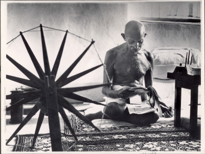 Indian Leader Mohandas Gandhi Reading As He Sits Cross-Legged On Floor by Margaret Bourke-White Pricing Limited Edition Print image