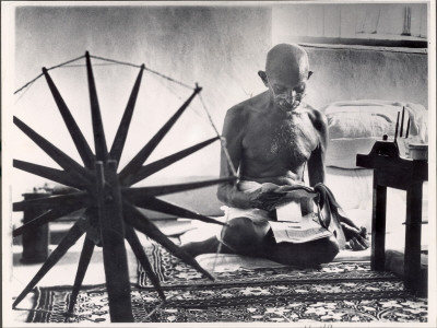 Indian Leader Mohandas Gandhi Reading As He Sits Cross-Legged On Floor by Margaret Bourke-White Pricing Limited Edition Print image