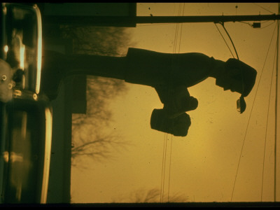 Advertising Sign Looming Over Heavy Traffic - Hazardous Distraction by Ralph Crane Pricing Limited Edition Print image