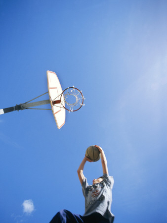 A Teenage Boy Jumping With A Basketball by Frank Chmura Pricing Limited Edition Print image