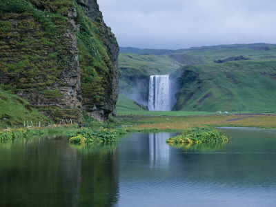 A Waterfall Skogafoss Reflecting In Water, Iceland by Johannes Long Pricing Limited Edition Print image
