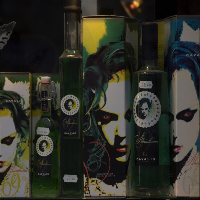 Shop Window Bottles Green Boxes Printed Faces Red Blue Green Blac White Yellow by Mike Burton Pricing Limited Edition Print image