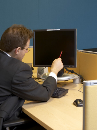 Office Life And Interiors Part Two, Man Sitting At Desk Pointing At Computer Screen by Richard Bryant Pricing Limited Edition Print image