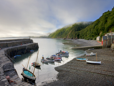 Fishing Boats Moored In The Harbour At Clovelly, Devon, England by Adam Burton Pricing Limited Edition Print image