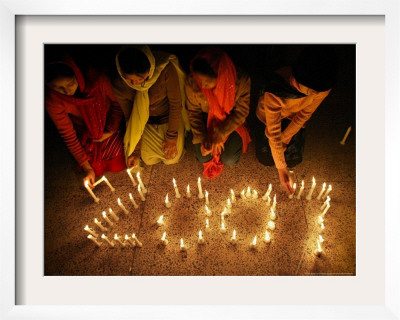 Pakistani Christian Girls Create The Digits Of 2007 With Lit Candles by Anjum Naveed Pricing Limited Edition Print image