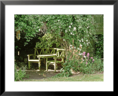 Rustic Wooden Chairs With Table In Secluded Area Of Garden by Mark Bolton Pricing Limited Edition Print image