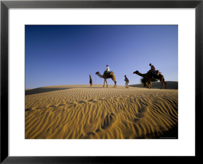 Caravan Of People And Camels In The Thar Desert, Rajasthan State, India by Marco Simoni Pricing Limited Edition Print image