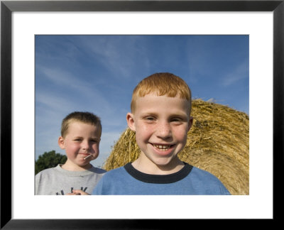 Two Young Kids By A Haybale In Greenleaf, Kansas by Joel Sartore Pricing Limited Edition Print image