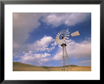 Old Windmill On Ranch Under Blue Sky With Clouds by John Eastcott & Yva Momatiuk Pricing Limited Edition Print image