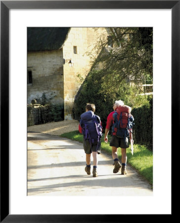 Two Walkers With Rucksacks On The Cotswold Way Footpath, Stanton Village, The Cotswolds, England by David Hughes Pricing Limited Edition Print image