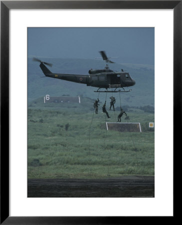 Soldiers Rappel From A Helicopter During Training Exercises by Karen Kasmauski Pricing Limited Edition Print image