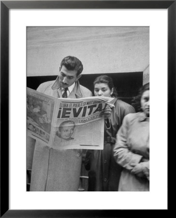 Couple Reading Newspaper Account Of The Death Of Evita Peron At 33 From Cancer by Alfred Eisenstaedt Pricing Limited Edition Print image