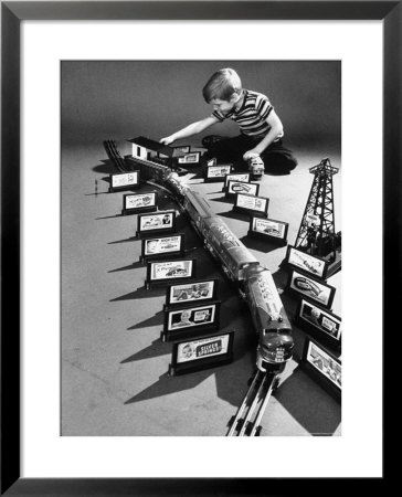 Little Boy Playing With A Toy Train And Billboard Set by Walter Sanders Pricing Limited Edition Print image