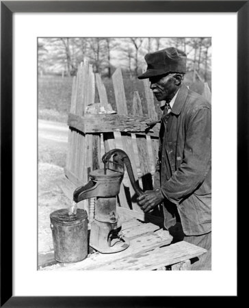 Old African American Sharecropper Dave Alexander Using Water Pump To Draw Water by Alfred Eisenstaedt Pricing Limited Edition Print image