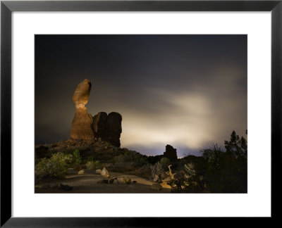 Balanced Rock Basks In The Glow Of The Town Of Moab by Jim Richardson Pricing Limited Edition Print image