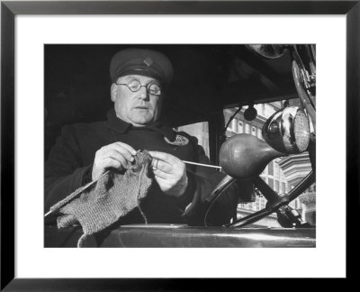 English Cabby Dutifully Knitting Sweater For British Soldier As He Waits At Taxi Rack On Oxford St by Carl Mydans Pricing Limited Edition Print image