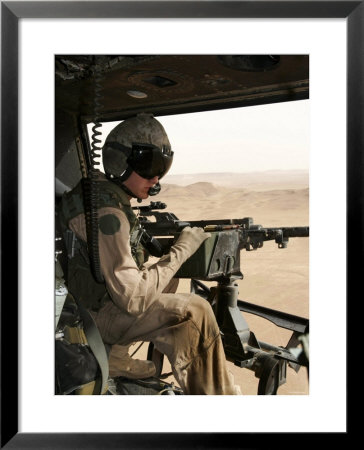 A Uh-1N Huey Crew Chief Scans The Ground To Find A Target by Stocktrek Images Pricing Limited Edition Print image