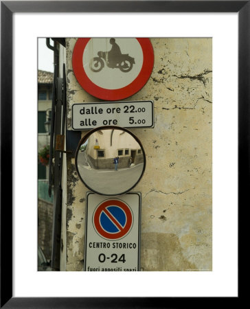 Road Signs And Wide Angle Mirror Along An Italian Road, Asolo, Italy by Todd Gipstein Pricing Limited Edition Print image