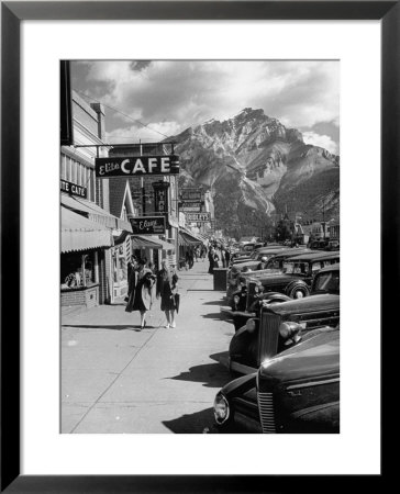 Pedestrians Walking Along Main Street In Resort Town With Cascade Mountain In The Background by Andreas Feininger Pricing Limited Edition Print image
