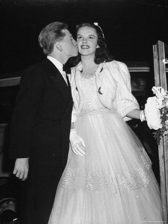 Mickey Rooney Kissing Judy Garland On The Cheek As They Arrive At Babes In Arms Movie Premiere by Peter Stackpole Pricing Limited Edition Print image