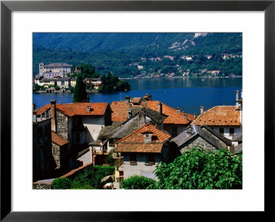 Village Roofs With Lago D'orta And Isola San Giulio In Background, Orta San Giulio, Piedmont, Italy by Glenn Van Der Knijff Pricing Limited Edition Print image